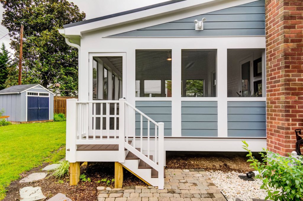 Mid-sized transitional screened-in back porch photo in DC Metro with decking and a roof extension by Atlas Moran Construction | Outdoor Photos | Porch | Landscaping | Landscape Design | Outdoor Living Space | Porch Design Ideas | Outdoor Living Space Ideas | Backyard Design