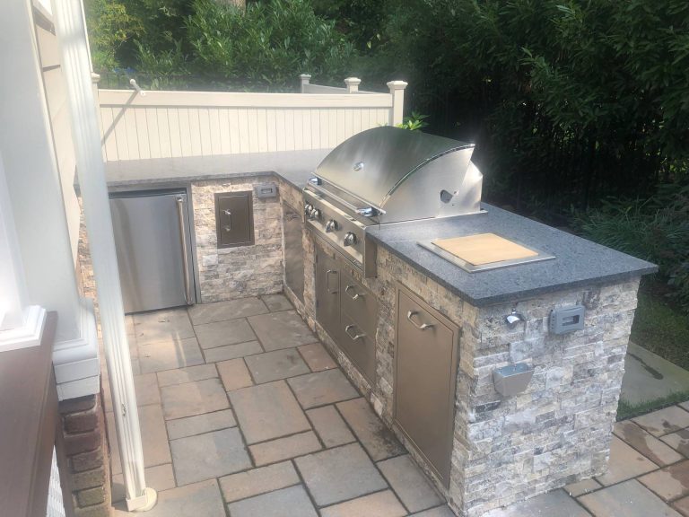 Mid-sized transitional side yard stone patio kitchen photo in New York with no cover