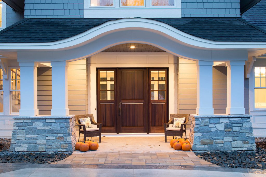 Mid-sized transitional stamped concrete front porch idea in Minneapolis with a roof extension by Gordon James Construction | Outdoor Photos | Porch | Landscaping | Landscape Design | Outdoor Living Space | Porch Design Ideas | Outdoor Living Space Ideas | Backyard Design