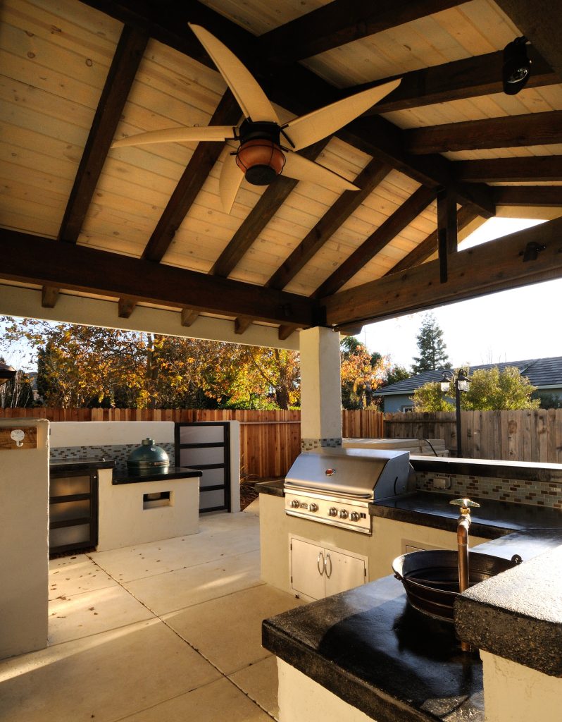 Mid-sized trendy backyard concrete patio kitchen photo in Sacramento with a roof extension