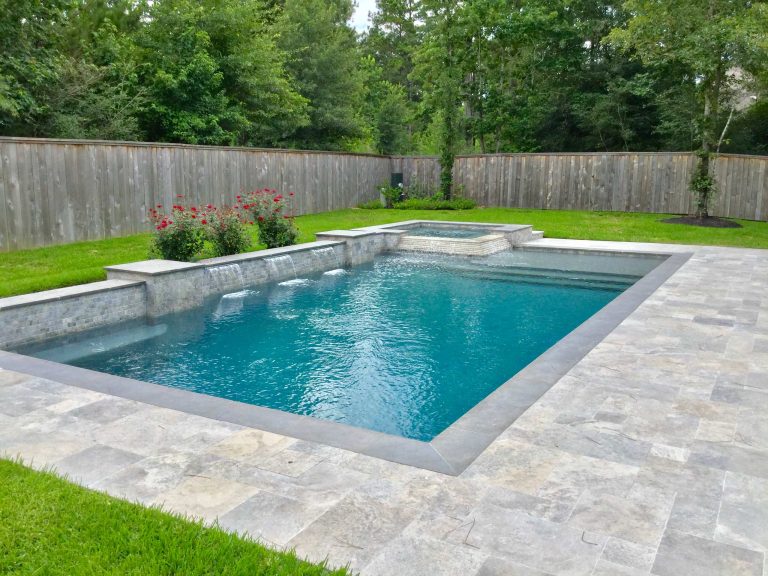 Mid-sized trendy backyard stone and rectangular lap hot tub photo in Houston