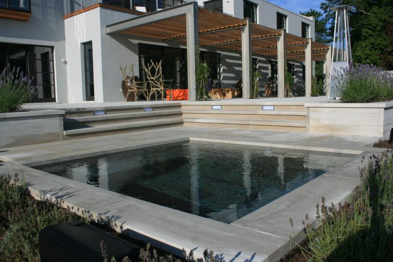 Mid-sized trendy backyard stone and rectangular lap hot tub photo in New York