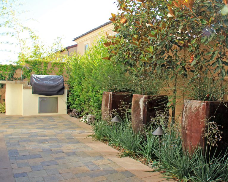 Mid-sized trendy backyard tile patio kitchen photo in Orange County with no cover