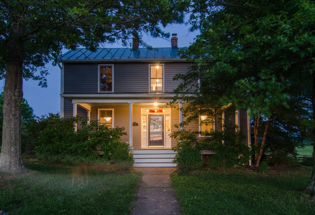 Mid-sized trendy brick front porch photo in DC Metro with a roof extension by Reader & Swartz Architects, P.C. | Outdoor Photos | Porch | Landscaping | Landscape Design | Outdoor Living Space | Porch Design Ideas | Outdoor Living Space Ideas | Backyard Design