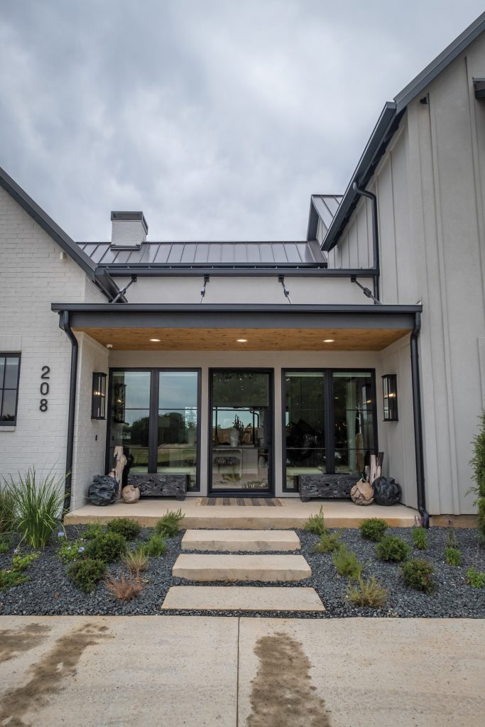 Mid-sized trendy concrete front porch photo in Dallas with a roof extension by J & V Painting | Outdoor Photos | Porch | Landscaping | Landscape Design | Outdoor Living Space | Porch Design Ideas | Outdoor Living Space Ideas | Backyard Design