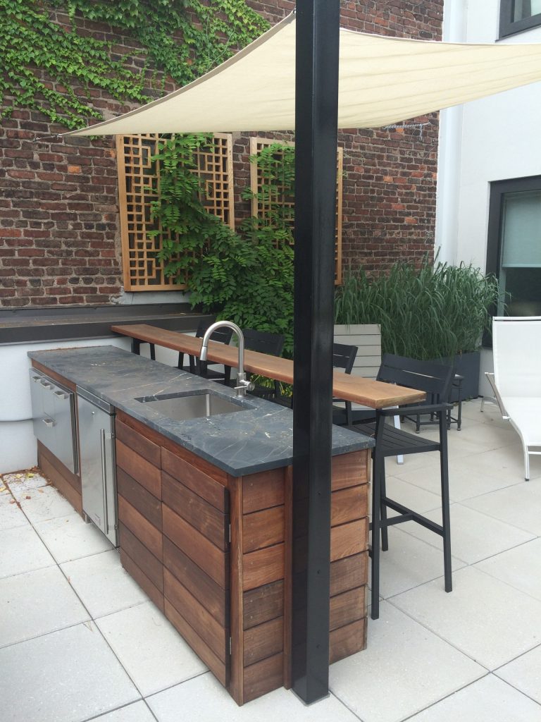 Mid-sized trendy courtyard tile patio kitchen photo in New York with no cover