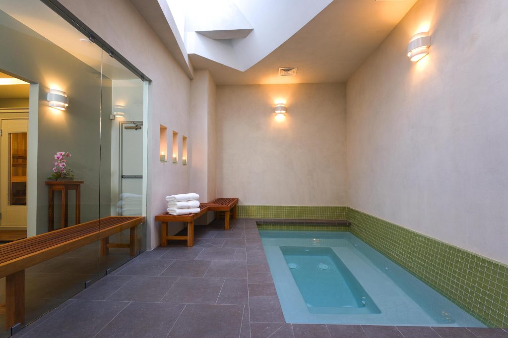 Mid-sized trendy indoor stone and rectangular hot tub photo in Los Angeles