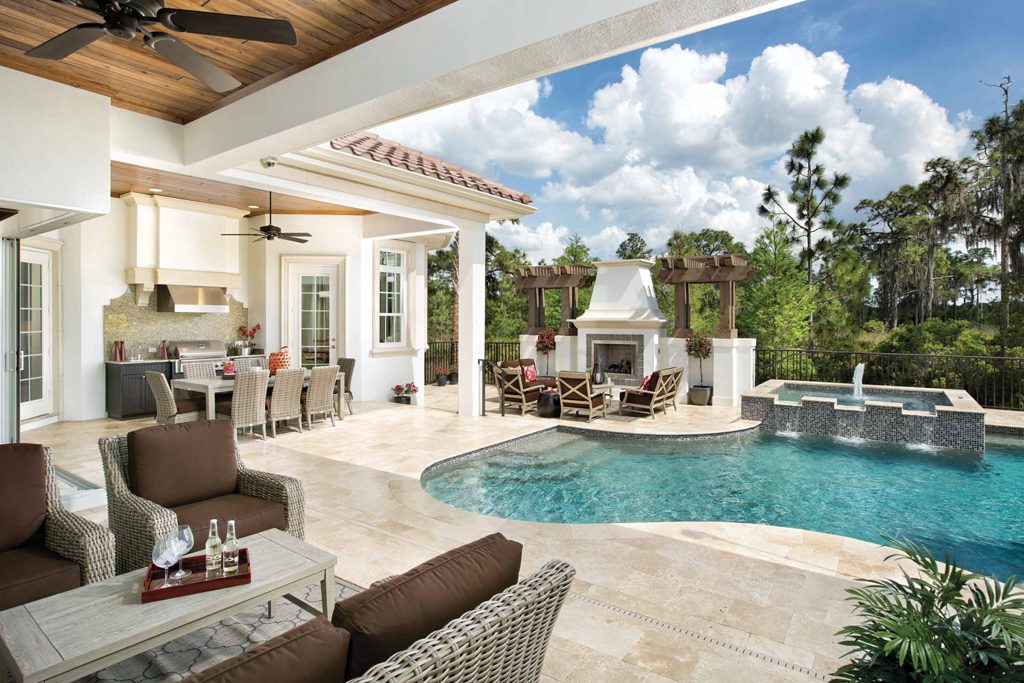 Mid-sized tuscan backyard stone and custom-shaped pool fountain photo in Orlando