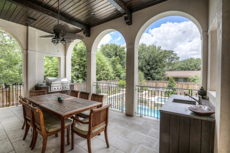 Mid-sized tuscan backyard tile patio kitchen photo in Houston with a roof extension