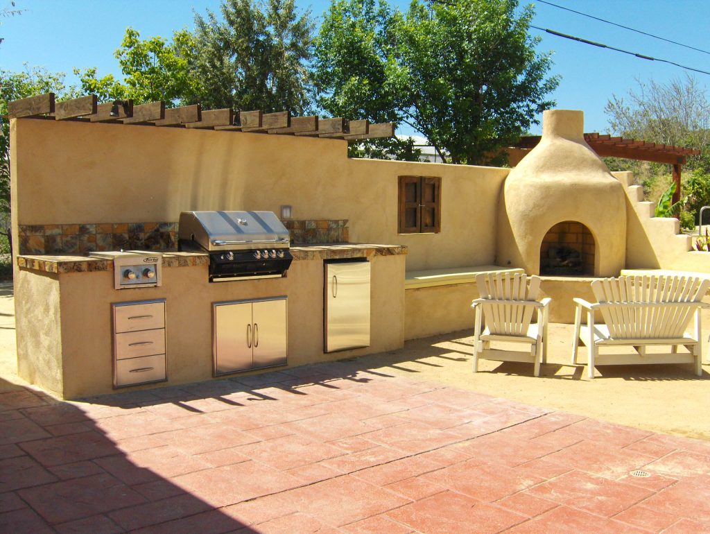 Mid-sized tuscan backyard tile patio kitchen photo in Los Angeles with no cover