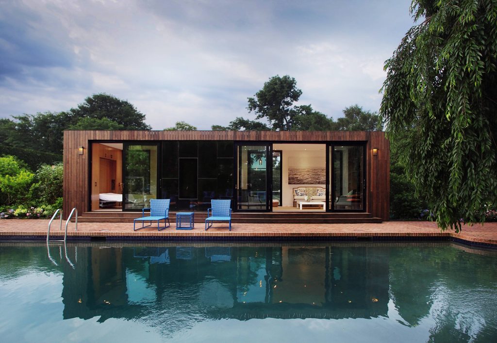 Minimalist brick pool house photo in New York
