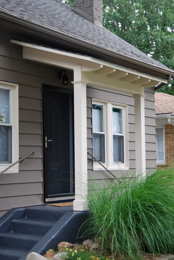 Mission style awning. Simple and straightforward. Built with pvc lumber to withstand harsh Michigan winters. Antique cast iron fixture lights the way.