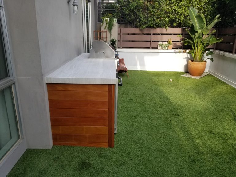 Modern outdoor kitchen with wood walls