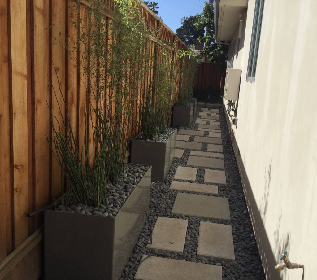 Modern walkway design with concrete pavers and La Paz pebbles