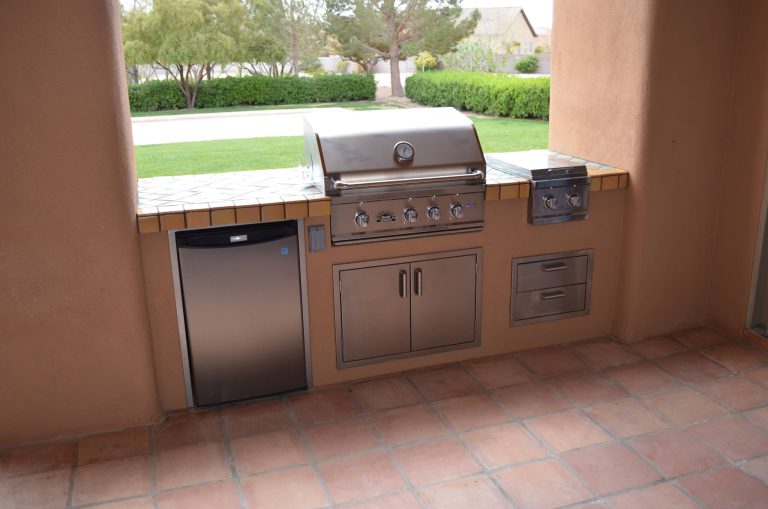 Mountain style backyard stone patio kitchen photo in Las Vegas