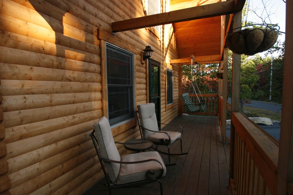 Mountain style front porch photo in Philadelphia with decking and a roof extension by Conestoga Log Cabins | Outdoor Photos | Porch | Landscaping | Landscape Design | Outdoor Living Space | Porch Design Ideas | Outdoor Living Space Ideas | Backyard Design