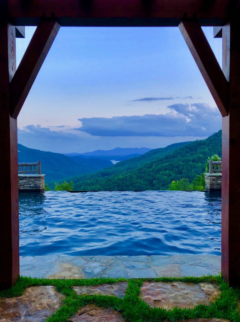 Mountain style pool photo in Other