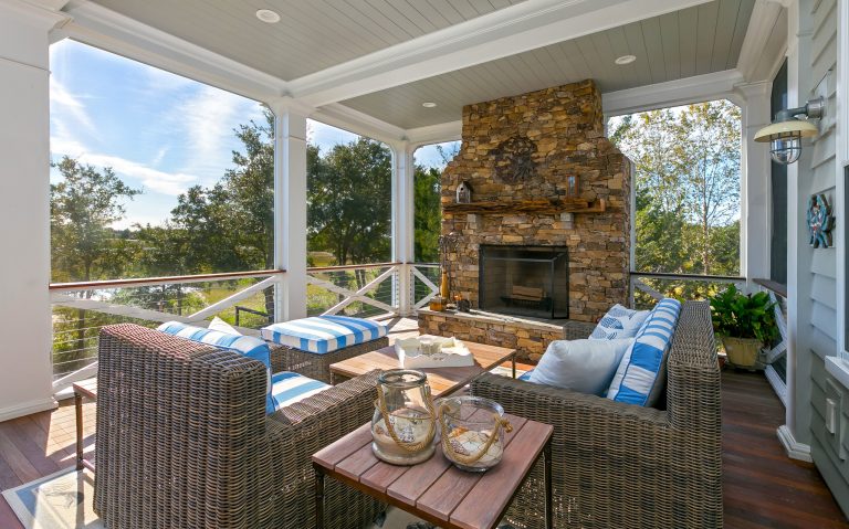 Natural-Stone Fireplace, Detailed Porch Design, and Cozy Wicker Seating at a Custom Lowcountry Home