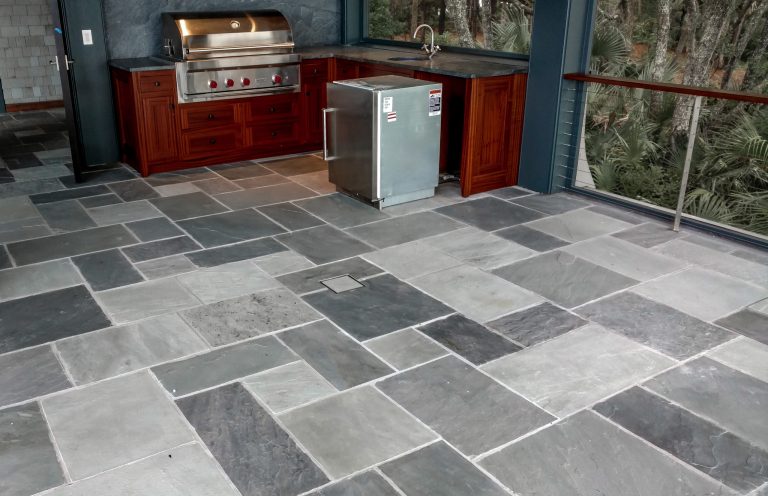 Natural cleft stone sawed in ashlar pattern with stone infinity drain in center of floor