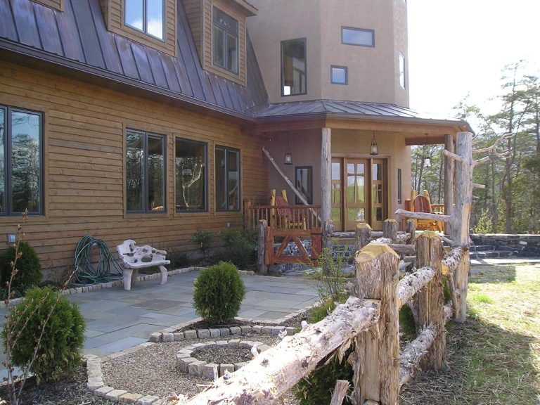 Natural wood fencing and landscaping blurs the line between the home and it's surroundings.