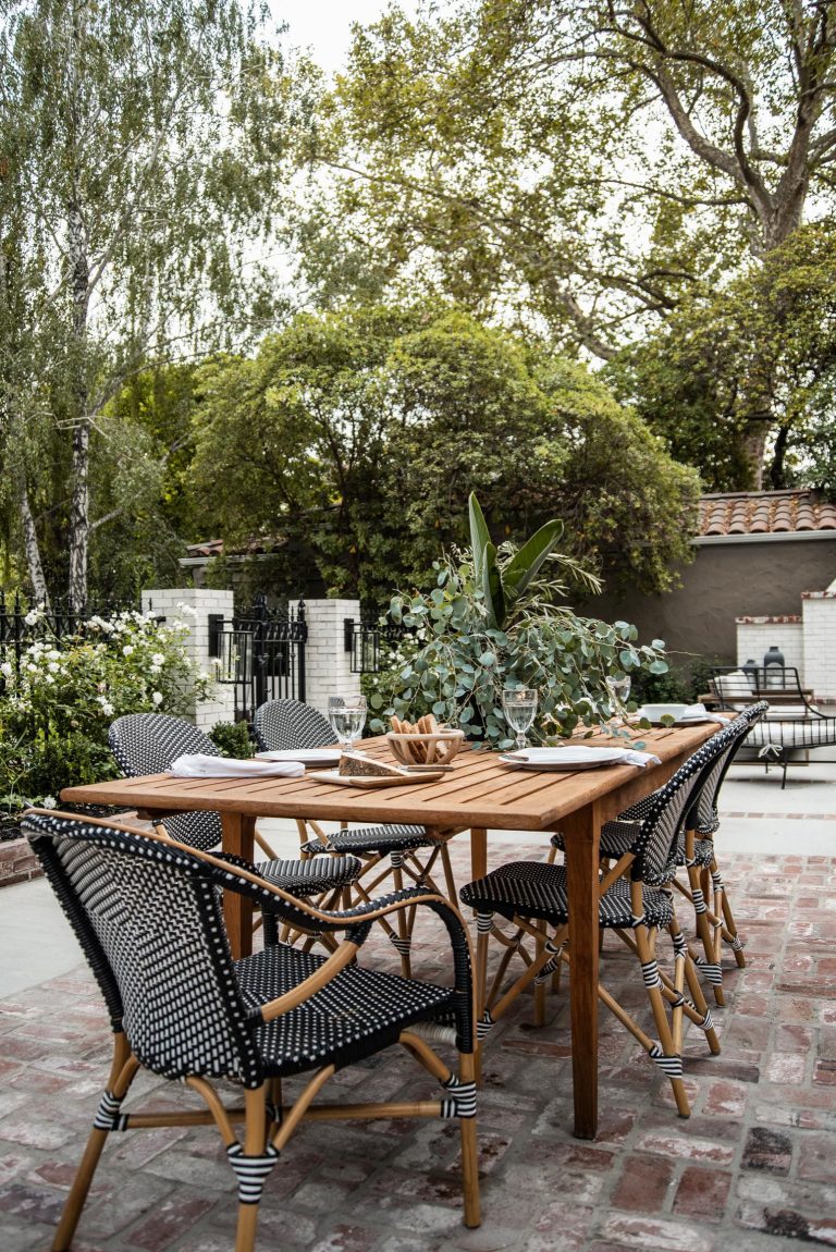 Natural wood paired with black and white accent chairs from Article come together for a dining table that seats up to ten. The perfect setting for your next dinner party, or back yard bbq.