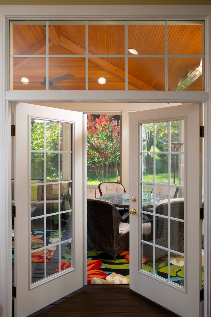 New French doors were installed to provide entry and exit from inside the house to the new sunroom addition. This is the view looking out into the patio and screened porch from inside the home. by Design Builders, Inc. | Outdoor Photos | Porch | Landscaping | Landscape Design | Outdoor Living Space | Porch Design Ideas | Outdoor Living Space Ideas | Backyard Design