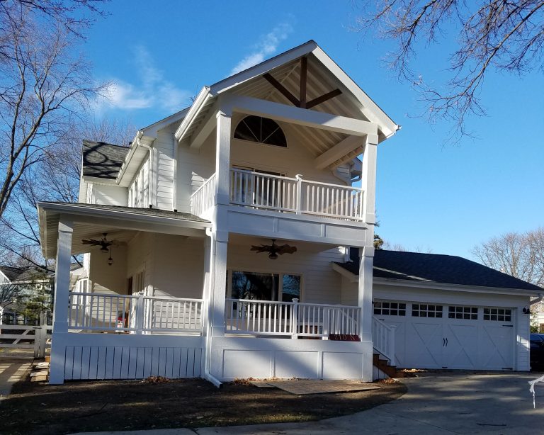 New covered wrap around front porch on existing farmhouse, with two story covered porch off second floor bedroom.