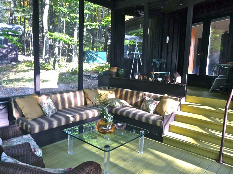 New screened in porch with built in sofa. Floor is painted chartreuse