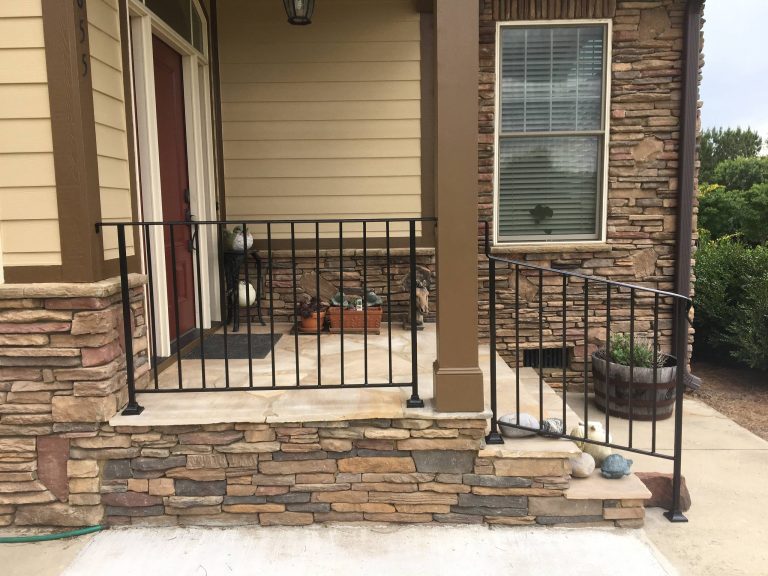 New wrought iron railings finish off this stone front porch