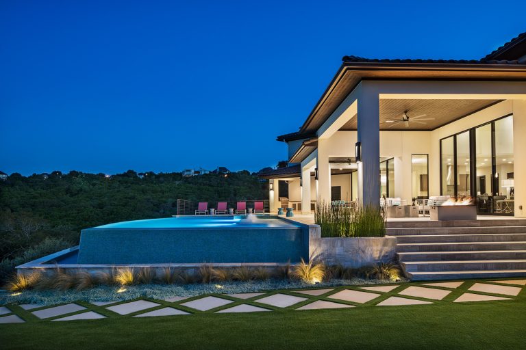 Night setting photo of the backyard pool and transition spaces. Photo by Rachel Paul Photography