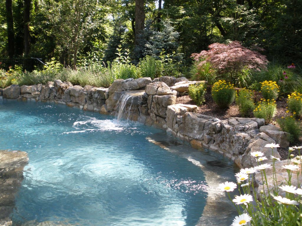 Notice the natural stone tile bench as well. There is over 28' of bench in this over-sized spa. matt meaney @ Artisan landscapes and pools