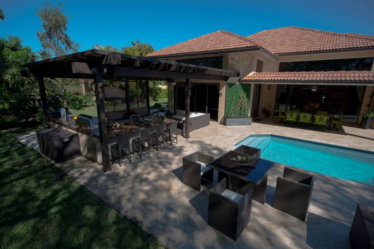 A complete contemporary backyard project was taken to another level of design. This amazing backyard was completed in the beginning of 2013 in Weston, Florida.

The project included an Outdoor Kitchen with equipment by Lynx, and finished with Emperador Light Marble and a Spanish stone on walls. Also, a 32” X 16” wooden pergola attached to the house with a customized wooden wall for the TV on a structured bench with the same finishes matching the Outdoor Kitchen. The project also consist of outdoor furniture by The Patio District, pool deck with gold travertine material, and an ivy wall with LED lights and custom construction with Black Absolute granite finish and grey stone on walls.

For more information regarding this or any other of our outdoor projects please visit our web-sight at www.luxapatio.com where you may also shop online at www.luxapatio/Online-Store.html. Our showroom is located in the Doral Design District at 3305 NW 79 Ave Miami FL. 33122 or contact us at 305-477-5141. by Luxapatio | Pool design | Pool Contracting | Swimming Pool Ideas | Swimming Pool Design Ideas