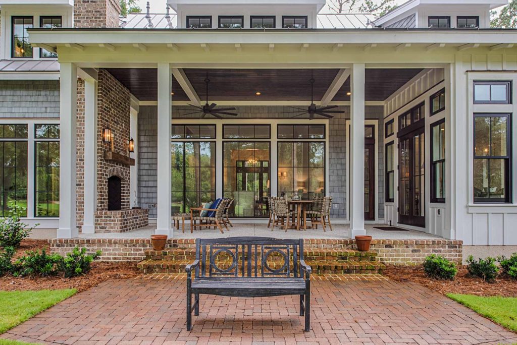 Open back porch, outdoor fireplace, and brick patio.