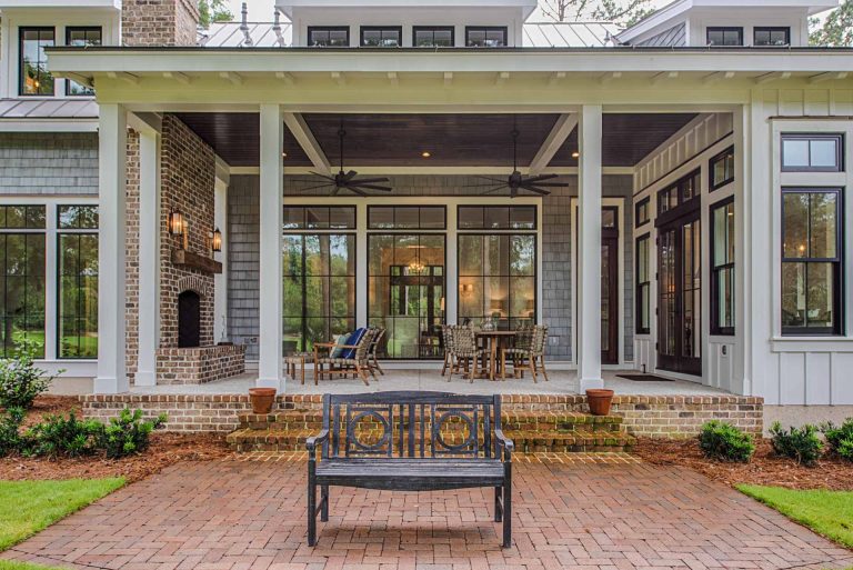 Open back porch, outdoor fireplace, and brick patio.