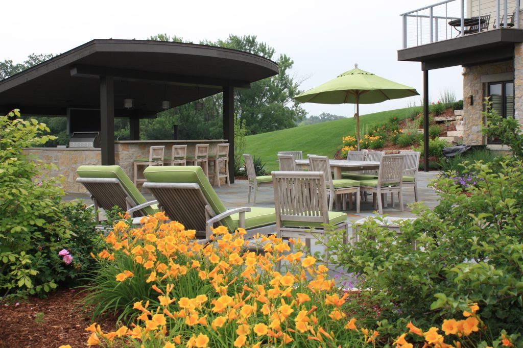 Our clients asked us to design a large outdoor living space for their family and guests. The main feature that they requested was an outdoor bar and grill.