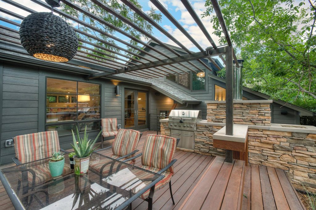 Outdoor Living with custom Medal Pergola and large stone format for bar area