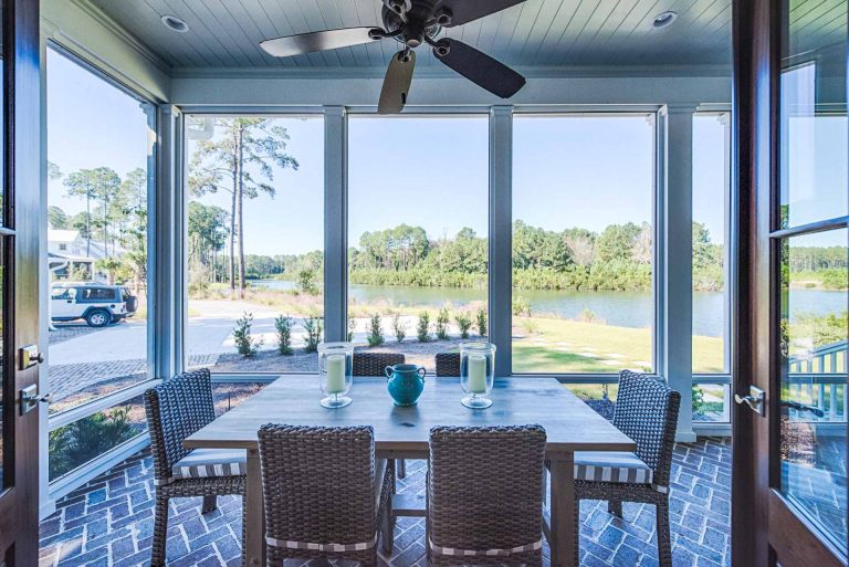 Outdoor dining area, herringbone pattern brick floor, and tongue and groove ceiling.