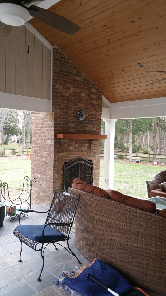 Outdoor fireplace with rough sawn cedar mantle.