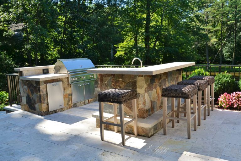 Outdoor kitchen and bar seating area uncovered
