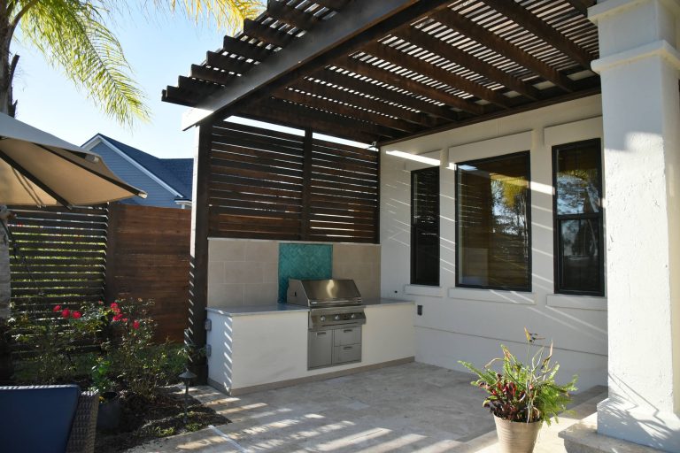Outdoor kitchen deck - contemporary backyard outdoor kitchen deck idea in Jacksonville with a pergola