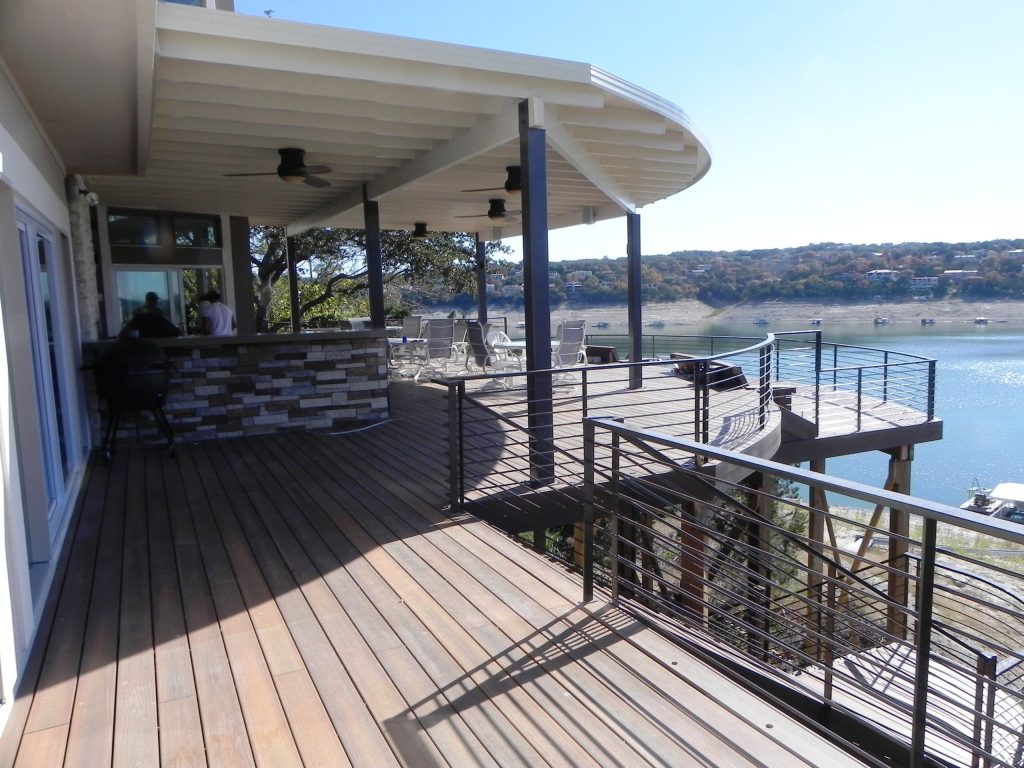 Outdoor kitchen deck - large contemporary backyard outdoor kitchen deck idea in Austin with a roof extension