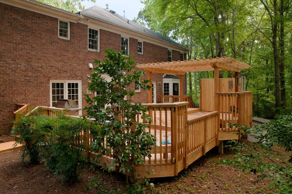 Outdoor kitchen deck - large traditional backyard outdoor kitchen deck idea in Atlanta with a pergola