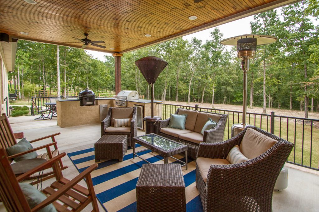 Outdoor kitchen deck - large transitional backyard outdoor kitchen deck idea in Little Rock with a roof extension