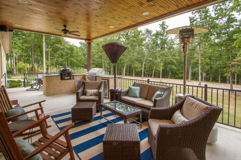 Outdoor kitchen deck - large transitional backyard outdoor kitchen deck idea in Little Rock with a roof extension