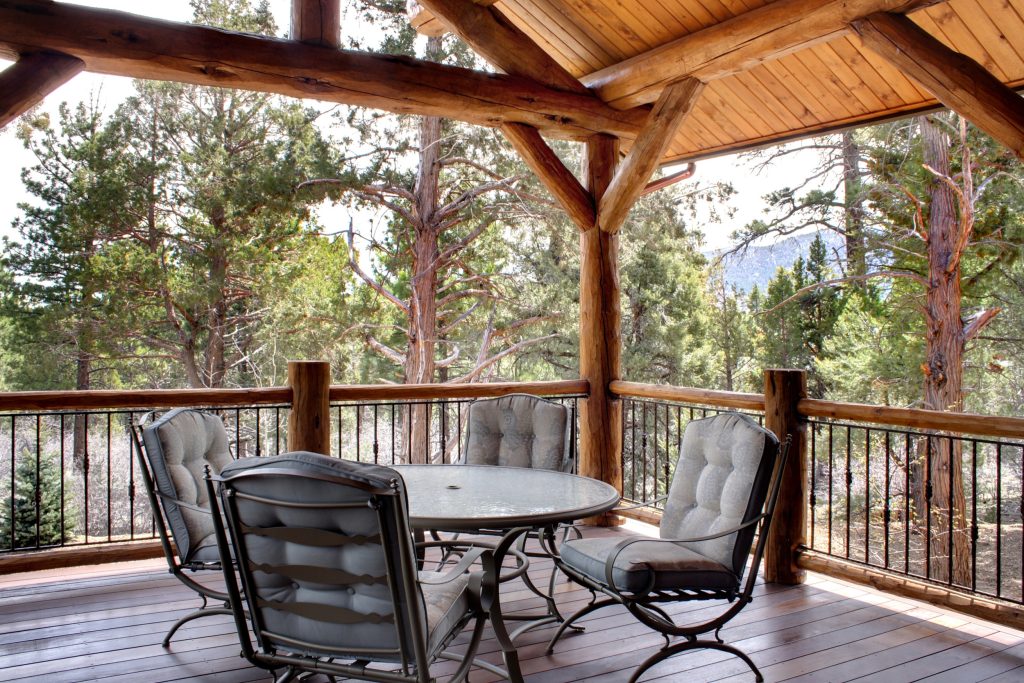 Outdoor kitchen deck - mid-sized rustic backyard outdoor kitchen deck idea in Atlanta with a roof extension