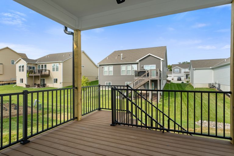 Outdoor kitchen deck - small craftsman backyard second story metal railing outdoor kitchen deck idea in Kansas City with a roof extension