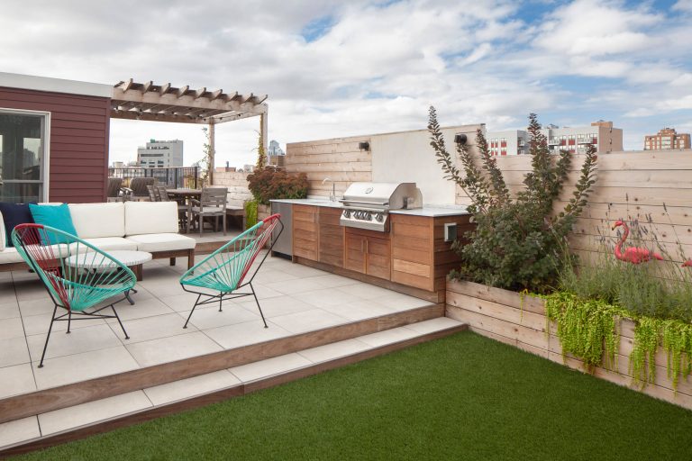 Outdoor kitchen deck - transitional outdoor kitchen deck idea in New York with a pergola