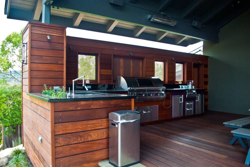 Outdoor kitchen faced with ipe. Custom door and windows made of ipe and corten steel. Full range of outdoor appliances. Outdoor electric heater for usability during the colder months.