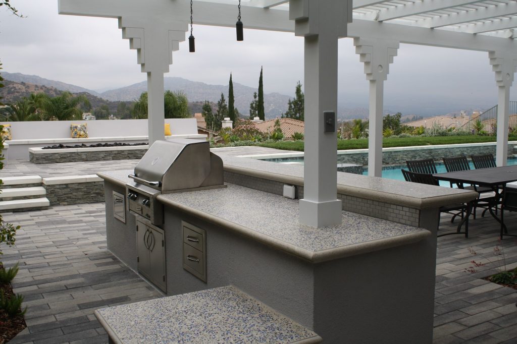 Outdoor kitchen, fire pit, outdoor dining room, and swimming pool