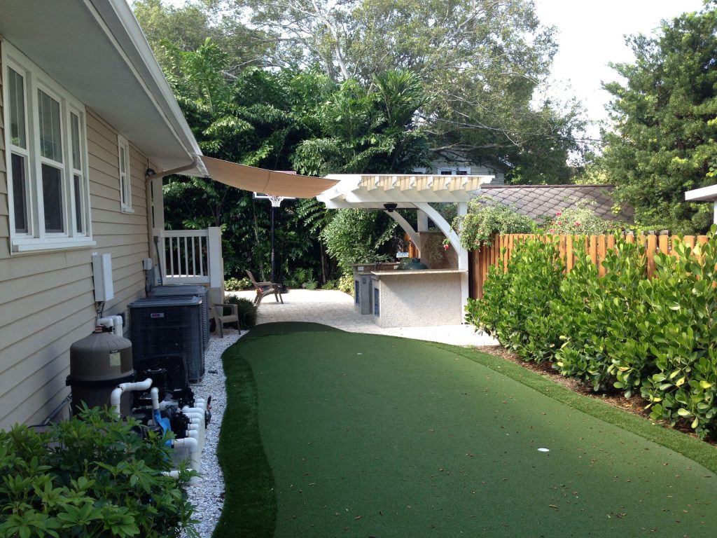 Outdoor kitchen, granite counters, crushed shell, Summerset grill, big green egg, white pergola, cedar, putting green, sail shade, polycarbonate roof, bar top